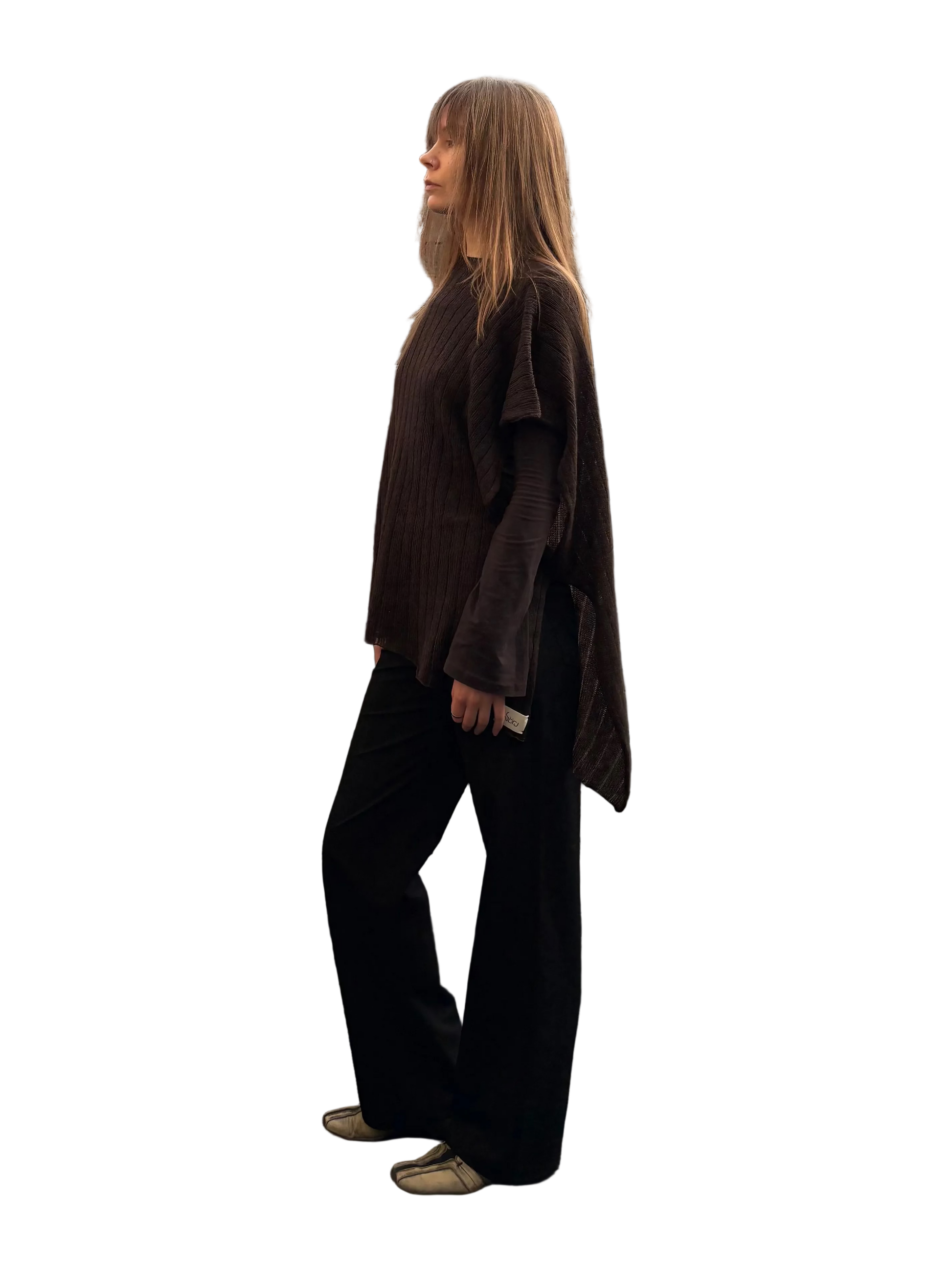 Person standing on a rooftop with wooden panels and buildings in the background